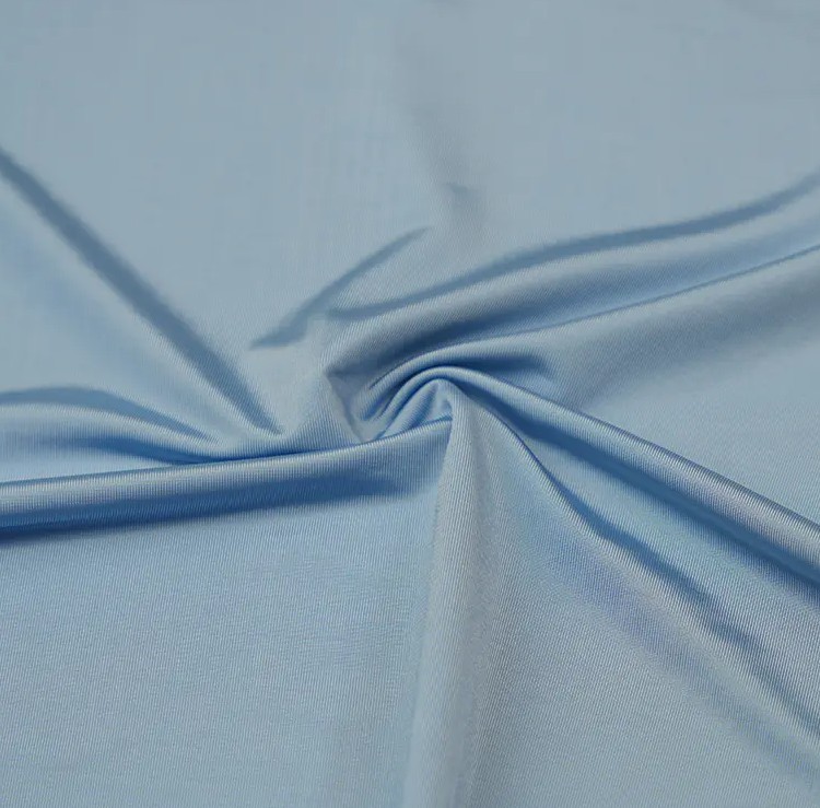 How do cooling fabrics achieve their cooling effect?